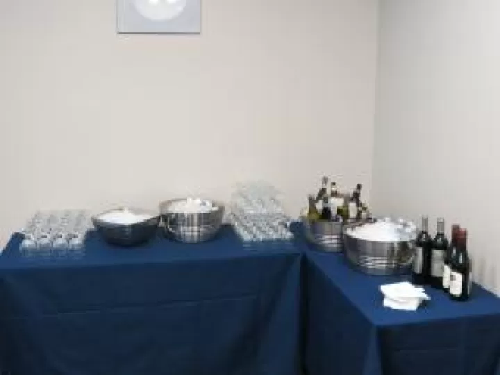 Ice, glasses, and bottles of wine arranged for a catered meeting